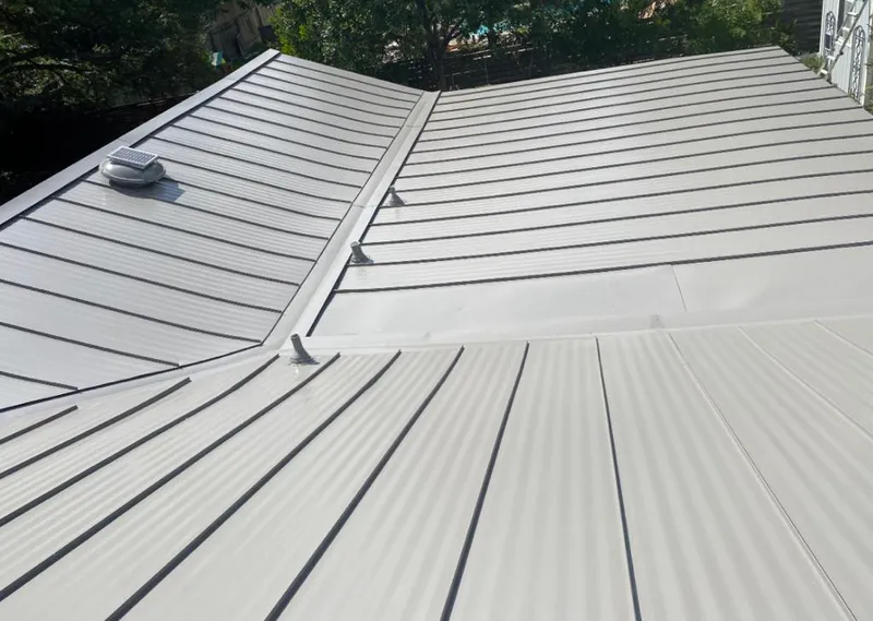 Solar attic fan installed on a metal roof for Roof Ventilation in South Houston