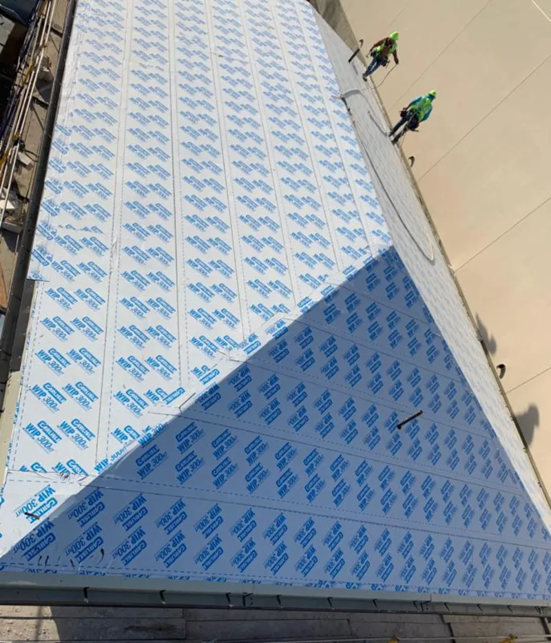 Professional roofers installing underlayment on a metal roof in South Houston